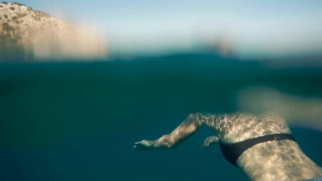 Underwater woman in bikini swimming in slow motion 
