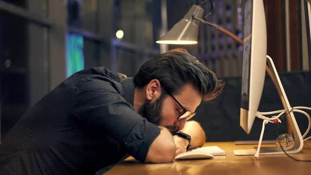 tired businessman sleeping on working place . tired workaholic