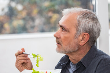 man eating salad, diet and health concept