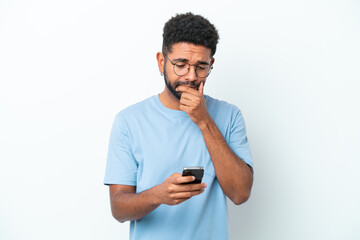 Young Brazilian man isolated on white background thinking and sending a message