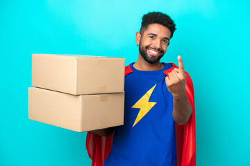 Super Hero delivery Brazilian man isolated on blue background doing coming gesture