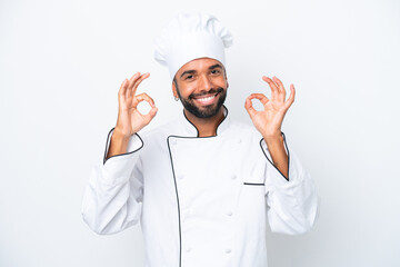 Young Brazilian chef man isolated on white background showing an ok sign with fingers