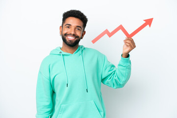 Young Brazilian man isolated on white background holding a catching a rising arrow with happy expression