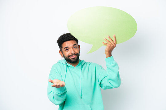 Young Brazilian man isolated on white background holding an empty speech bubble and having doubts