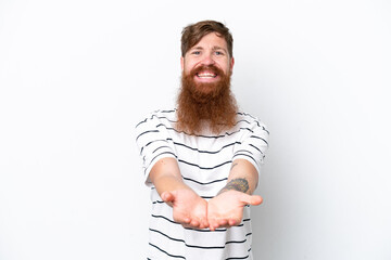 Redhead man with beard isolated on white background holding copyspace imaginary on the palm to...