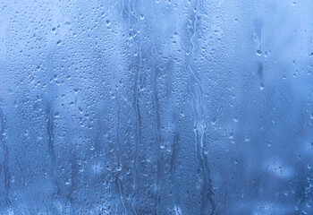 Window glass with water drips as a background.