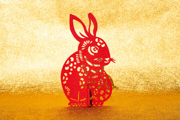 Chinese New Year of Rabbit mascot paper cut on golden background at horizontal composition no logo no trademark
