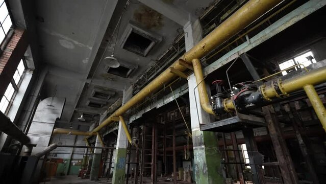 The interior of the destroyed production in the factory since the days of the Soviet Union. Dolly camera shot