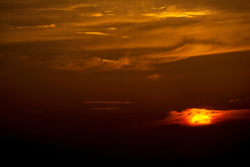 Dramatic colorful sunset sky with clouds over the mountains