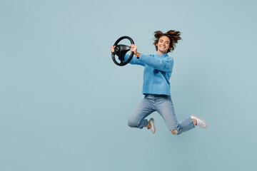 Full body side view young excited woman wear knitted sweater look camera hold steering wheel...