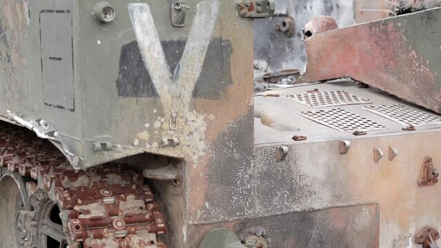 Destroyed, wrecked and burned T-72 tank with a designation V on it. Russian-Ukrainian conflict in 2022. Destroyed Russian military equipment. War of Russia against Ukraine.