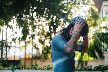 Fototapeta premium A bearded cyclist putting on his helmet for his morning bike ride