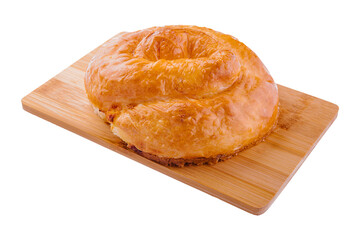 Fresh twisted bun on wooden board