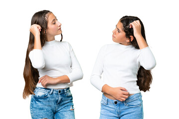 Friends girls holding gift and a birthday cake over isolated chroma key background having doubts...