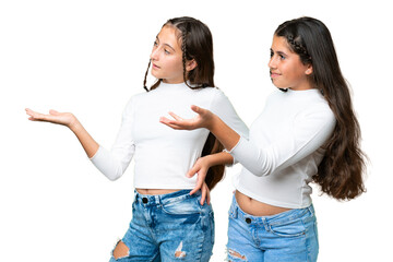 Friends girls holding gift and a birthday cake over isolated chroma key background pointing back...