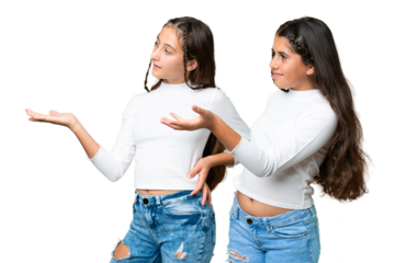 Friends girls holding gift and a birthday cake over isolated chroma key background pointing back and presenting a product