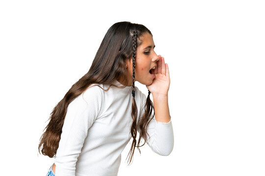 Young girl over isolated chroma key background shouting with mouth wide open to the lateral