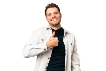 Brazilian man over isolated chroma key background giving a thumbs up gesture