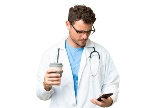 Brazilian doctor man over isolated chroma key background holding coffee to take away and a mobile