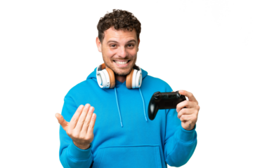Brazilian man playing with a video game controller over isolated chroma key background inviting to come with hand. Happy that you came