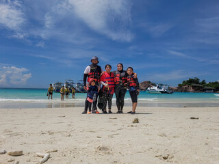 Redang, Malaysia - May 10, 2022 Asian family at the beach. Vacation concept.