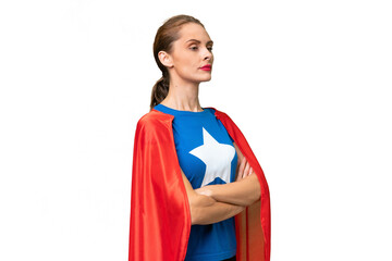 Young caucasian woman over isolated background in superhero costume with arms crossed © luismolinero