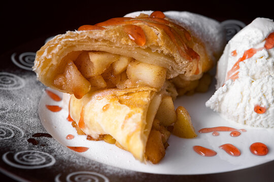 Baked strudel with apple, jam and ice cream