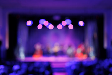 Fototapeta na wymiar Texture blur and defocus, background for design. Stage light at a concert show. Artists perform on scene in light and smoke.