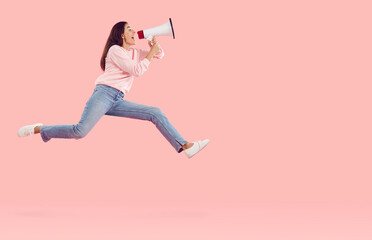 Side view happy joyful excited woman in pink sweatshirt and blue jeans hurrying to share urgent...