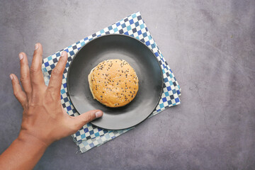 top view of hand reaching for a burger 