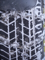 Obraz na płótnie Canvas Close-up of car tyre fasten with chain