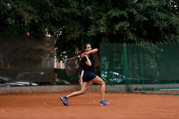 view of sports female tennis player with racket ready to hit tennis ball flying towards her.