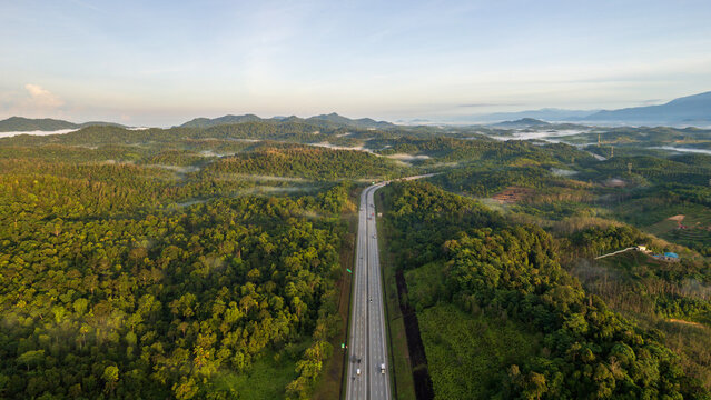 aerial view of highway in the middle of forest © MohdZairi