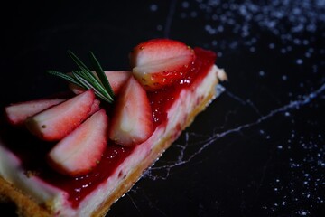 Photo of strawberry cake on a black background