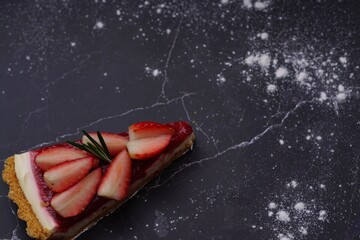Photo of strawberry cake on a black background