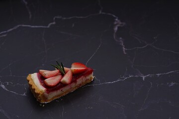 Photo of strawberry cake on a black background