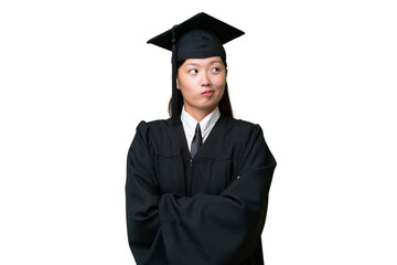 Young university graduate Asian woman over isolated background making doubts gesture while lifting the shoulders