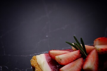 Photo of strawberry cake on a black background