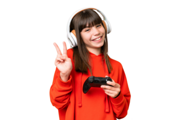 Little caucasian girl playing with a video game controller over isolated background smiling and showing victory sign