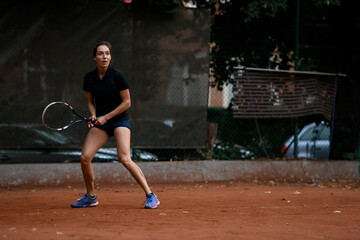Ready to hit. Active female tennis player with racket ready to hit tennis ball.