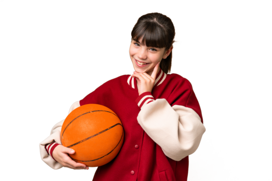 Little caucasian girl playing basketball over isolated background thinking an idea while looking up
