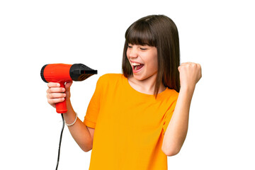 Little Caucasian girl holding a hairdryer over isolated background celebrating a victory