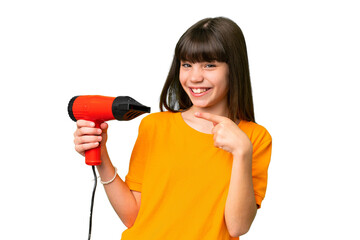 Little Caucasian girl holding a hairdryer over isolated background and pointing it