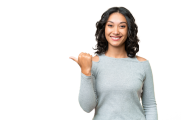 Young Argentinian woman over isolated background pointing to the side to present a product