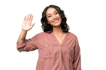 Young Argentinian woman over isolated background saluting with hand with happy expression