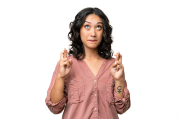 Young Argentinian woman over isolated background with fingers crossing and wishing the best