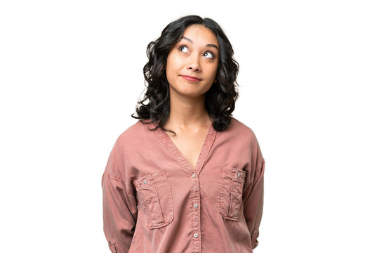 Young Argentinian Woman Over Isolated Background And Looking Up