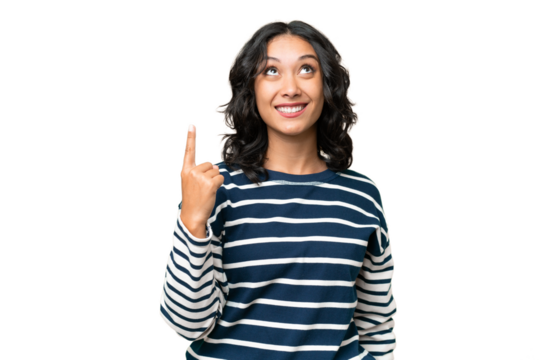 Young Argentinian woman over isolated background pointing up and surprised