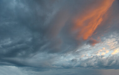 Russia. Eastern Siberia. Dramatic clouds in the evening sky over the Sayan Mountains.