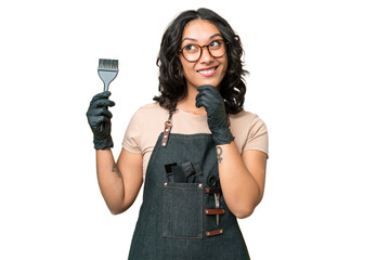 Young argentinian hairdresser woman over isolated background and looking up